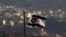 FILE - An Israeli flag flies near the village of Majdal Shams in the Israeli-controlled Golan Heights, Oct. 11, 2018.