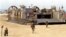 FILE - Marines race onto the beach from amphibious landing craft during mock exercise.