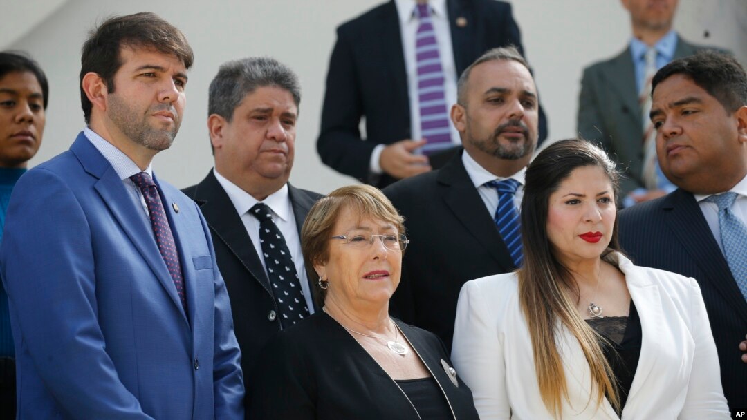 FILE - U.N. High Commissioner for Human Rights Michelle Bachelet poses for a photo with opposition lawmakers on the steps of the national assembly in Caracas, Venezuela, June 21, 2019. 