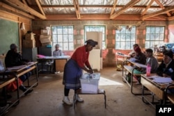 A Mosotho woman casts her ballot during Lesotho general elections at a polling station on June 3, 2017 in the remote village of Nyakosoba.