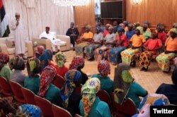Nigerian President Muhammadu Buhari (left) addresses 82 freed Chibok schoolgirls during a meeting with them in Abuja, Nigeria, May 7, 2017. (Source - @MBuhari)