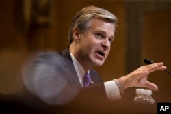 FILE - FBI Director Christopher Wray testifies during a hearing on Capitol Hill, May 7, 2019.