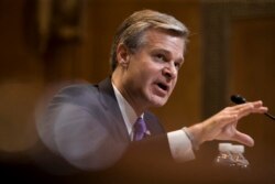 FILE - FBI Director Christopher Wray testifies during a hearing, on Capitol Hill, May 7, 2019.