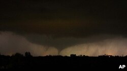 A tornado on the ground makes it way through the night near Salin, Kansas, during the third day of severe weather and multiple tornado sightings, April 14, 2012.
