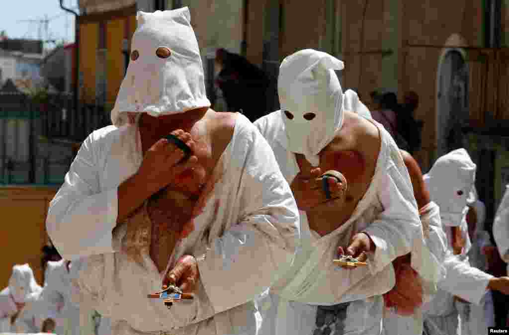 Penitents take part in a religious procession in Guardia Sanframondi, south Italy.