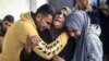 Palestinians mourn after identifying corpses of relatives killed in overnight Israeli bombardment on the southern Gaza Strip at Al-Najjar hospital in Rafah on February 8, 2024, as the conflict between Israel and Hamas enters its fifth month.
