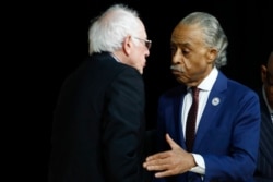 FILE - In this Feb. 26, 2020, file photo, Rev. Al Sharpton greets Democratic presidential candidate Sen. Bernie Sanders, I-Vt., at the National Action Network South Carolina Ministers' Breakfast in North Charleston, S.C.