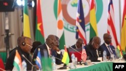 Liberia´s President George Weah (2nd L) and Ghana President Nana Akufo-Addo (2nd R) react during the 64th Economic Community of West African States (ECOWAS) Head of States and Government ordinary session in Abuja on December 10, 2023. 