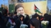 Iranians lay flowers beneath a billboard bearing a portrait of Hezbollah leader Hassan Nasrallah, who was killed in an Israeli air strike on Beirut's southern suburbs on September 27, during an anti-Israel protest in Palestine Square in Tehran on Septembe