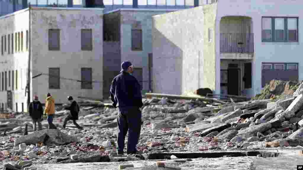 Raymond Simpson, Jr., with Atlantic City's Department of Public Works, looks out over debris from superstorm Sandy in Atlantic City, N.J., November 1, 2012.