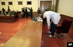 American student Otto Warmbier, right, bows as Warmbier is presented to the reporters, Feb. 29, 2016.