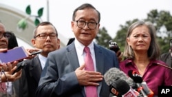 Cambodia's exiled opposition leader Sam Rainsy talks to the media outside Parliament House in Kuala Lumpur, Malaysia, Tuesday, Nov. 12, 2019.