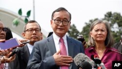 FILE: Cambodia's exiled opposition leader Sam Rainsy talks to the media outside Parliament House in Kuala Lumpur, Malaysia, Tuesday, Nov. 12, 2019. (AP Photo/Vincent Thian)