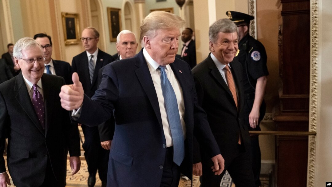 FILE - President Donald Trump, accompanied by Vice President Mike Pence, rear, Senate Majority Leader Mitch McConnell, left, and Sen. Roy Blunt, arrives to speak with lawmakers on Capitol Hill in Washington, March 10, 2020.