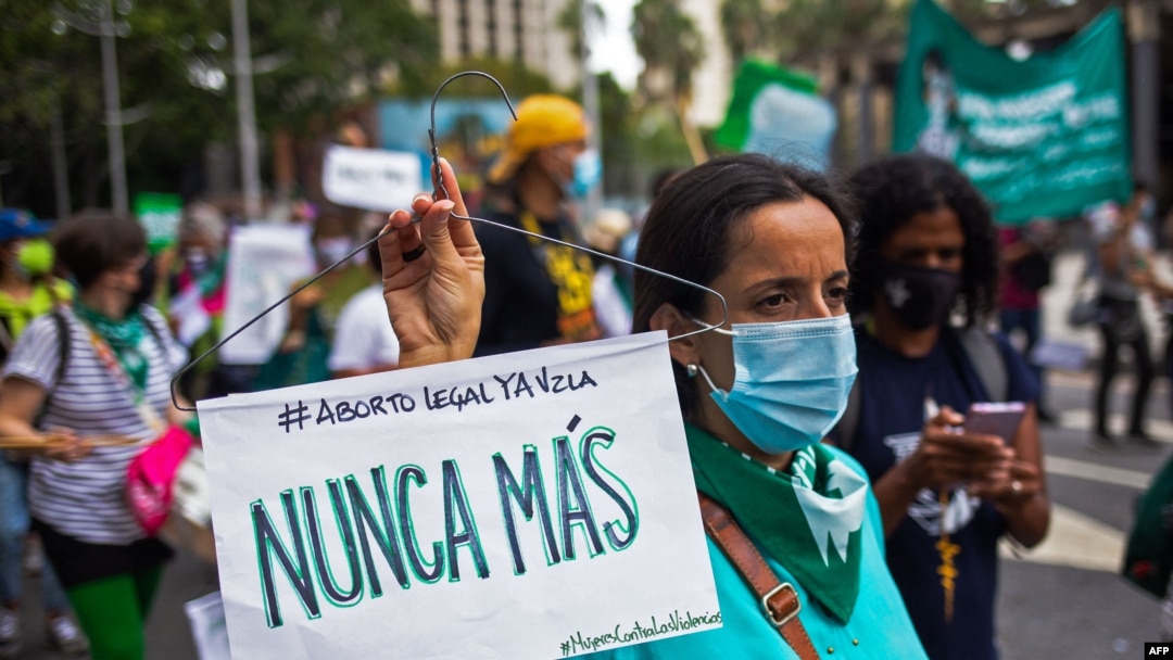Una mujer sostiene un cartel que reza "mujeres en lucha, nunca más", en referencia a los abortos clandestinos, durante una manifestación por la despenalización del aborto durante el Día Mundial de Acción por el Aborto Legal y Seguro en América Latina, en Caracas.