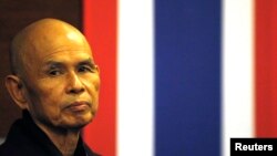 French-based Buddhist zen master Thich Nhat Hanh gestures during his arrival at Suvarnabhumi airport 