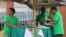 Volunteers with the upstart Belize Progressive Party gather near a polling station in downtown Belize City, Nov. 4, 2015.