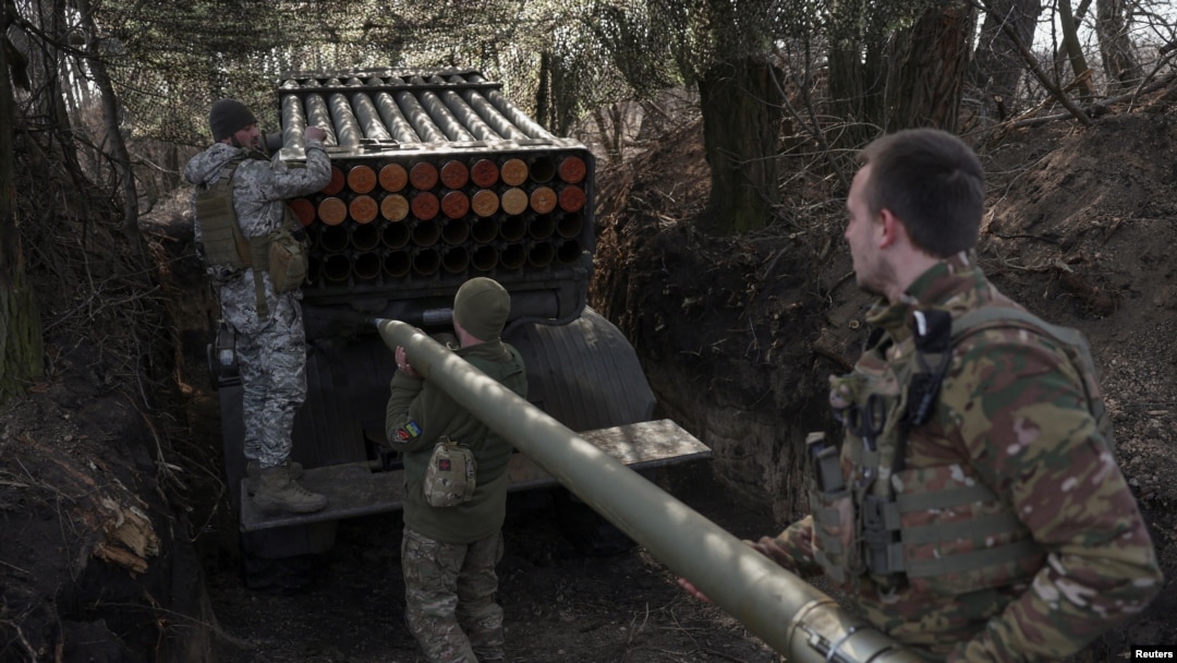 Ukrainian service members of the 68th Jaeger Brigade named after Oleksa Dovbush load a rocket into a BM-21 Grad multiple launch system at their position near the frontline town of Pokrovsk, in Donetsk region, Feb. 14, 2025. 