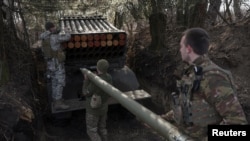 Ukrainian service members of the 68th Jaeger Brigade named after Oleksa Dovbush load a rocket into a BM-21 Grad multiple launch system at their position near the frontline town of Pokrovsk, in Donetsk region, Feb. 14, 2025. 