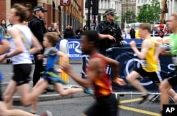Armed police guard the area during the Great Manchester Run in Manchester, England, May 28, 2017.