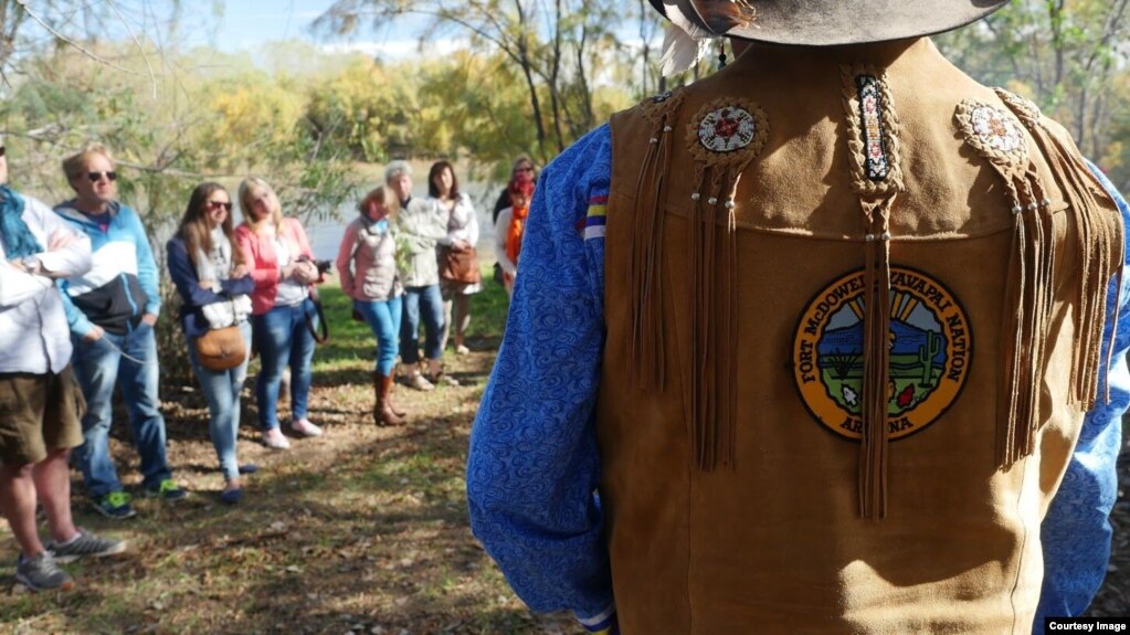 This undated photo shows a Yavapai tour guide speaking with a group of visitors to the Fort McDowell Yavapai Nation in Maricopa County, Arizona. Courtesy: AIANTA