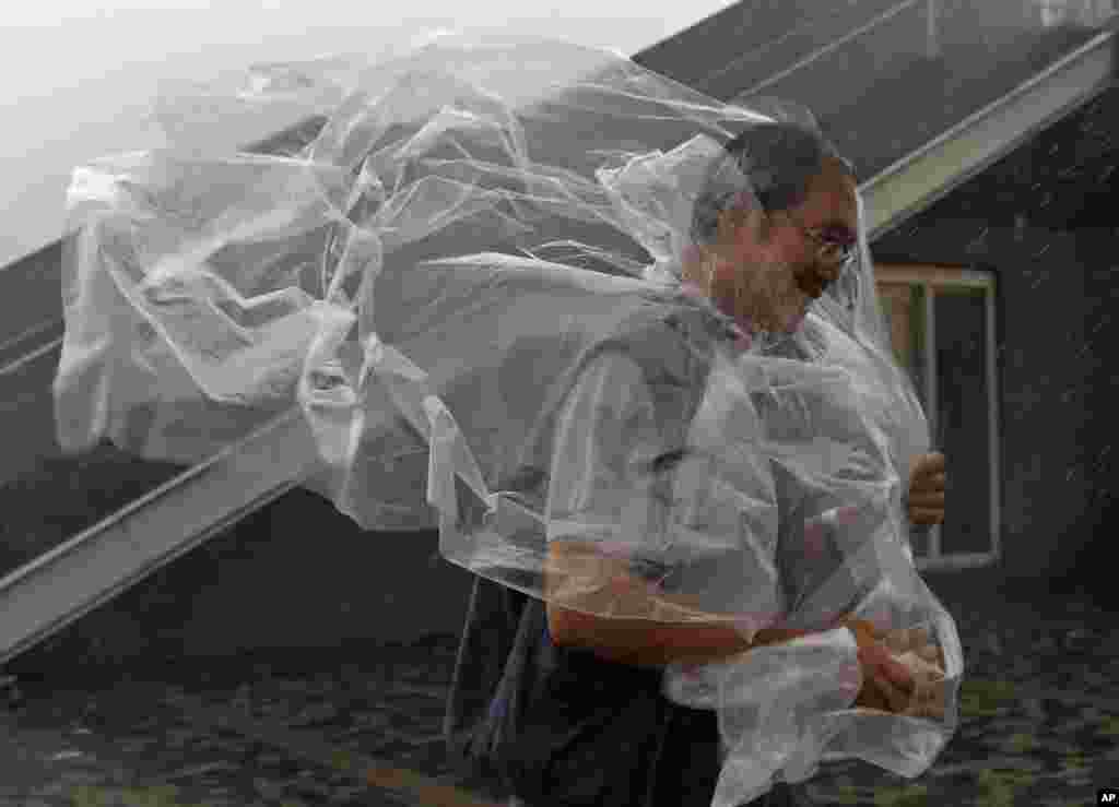 A man braves the wind on the waterfront of Victoria Habor as Typhoon Haima approaches Hong Kong.