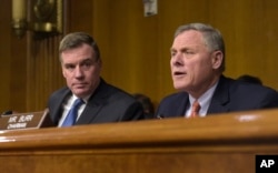 FILE - Senate Intelligence Committee Chairman. Sen. Richard Burr, R-N.C., right, joined by Vice Chairman Sen. Mark Warner, D-Va., left, speaks at the Senate Intelligence Committee hearing on Capitol Hill in Washington, March 30, 2017.