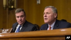 FILE - Senate Intelligence Committee Chairman. Sen. Richard Burr, R-N.C., right, joined by Vice Chairman Sen. Mark Warner, D-Va., left, speaks at the Senate Intelligence Committee hearing on Capitol Hill in Washington, March 30, 2017. 