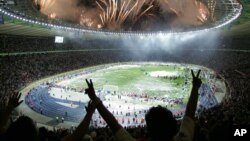 FILE - In this July 9, 2006, photo, Italian soccer fans celebrate after Italy beat France 5-3 in a penalty kick shootout to win the final of the soccer World Cup between Italy and France in the Olympic Stadium in Berlin, Germany.