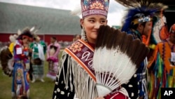 FILE - A young woman from the Lakota nation wears traditional clothing at an event celebrating National Aboriginal Day in Winnipeg, Manitoba, June 21, 2011.