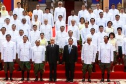 From left in the front row, Minister of Interior Ministry Sar Kheng, Prime Minister Hun Sen, National Assembly President Heng Samrin, King Norodom Sihamoni, Senate PresidentSay Chhum, Minister of Royal Palace Kong Samol, and lawmaker Tea Banh pose with the nation's lawmakers during a photo session in front of the National Assembly in Phnom Penh, Cambodia, Wednesday, Sept. 5, 2018. (AP Photo/Heng Sinith)