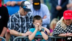 Supporters pray during a then-President-elect Donald Trump rally at the Ladd–Peebles Stadium, Saturday, Dec. 17, 2016, in Mobile, Ala. (AP Photo/Brynn Anderson)