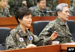 This handout photo released by the presidential Blue House shows South Korea's President Park Geun-Hye (L) during her visit to the headquarters of Third Army in Yongin, south of Seoul, on August 21, 2015.