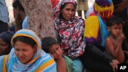 FILE - Rohingya women and children are seen at a temporary shelter in the Kalindi Kunj area of New Delhi, India, April 15, 2018.