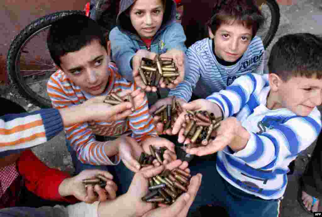 March 31: Palestinian children show bullet casings they gathered after clashes in the Palestinian refugee camp of Ein el-Hilweh near the southern port city of Sidon, Lebanon. (AP Photo/Mohammed Zaatari)