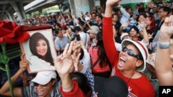 Supporters of Thailand's former Prime Minister Yingluck Shinawatra dance outside the Supreme Court after Yingluck failed to show up to hear a verdict in Bangkok Thailand, Aug. 25, 2017.