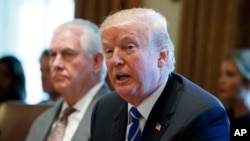 Secretary of State Rex Tillerson listens as President Donald Trump announces that the United States will designate North Korea a state sponsor of terrorism during a cabinet meeting at the White House, Nov. 20, 2017, in Washington.