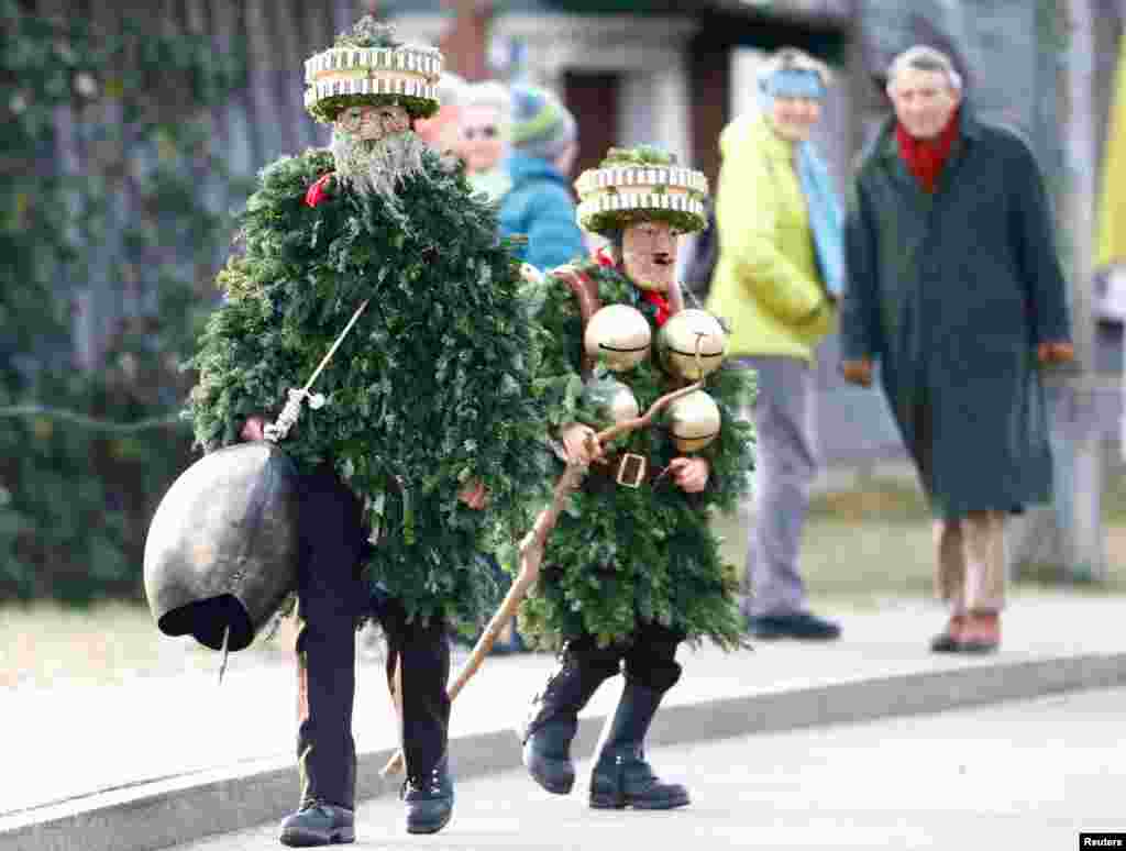 Men dressed as &quot;Chlaeuse&quot;, figures that scare away evil spirits, carry round bells and cowbells during the traditional &quot;Sylvesterchlausen&quot; in near the northeastern village of Urnaesch, Switzerland.