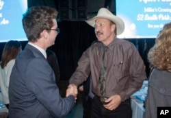 FILE - Congressional candidate Rob Quist meets with supporters during the annual Mansfield Metcalf Celebration dinner hosted by the state's Democratic Party in Helena, Mont., March 18, 2017.