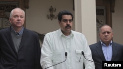 Venezuela's Vice President Nicolas Maduro (C), flanked by cabinet members, makes a statement about the health condition of Venezuela's President Hugo Chavez during a news conference in Caracas, December 12, 2012. 