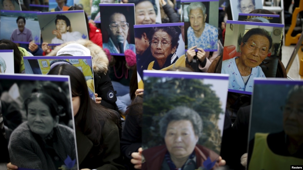 FILE - Students hold portraits of deceased former South Korean 