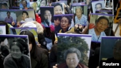 Students hold portraits of deceased former South Korean "comfort women" during a weekly anti-Japan rally in front of the Japanese Embassy in Seoul, South Korea, Dec. 30, 2015. 