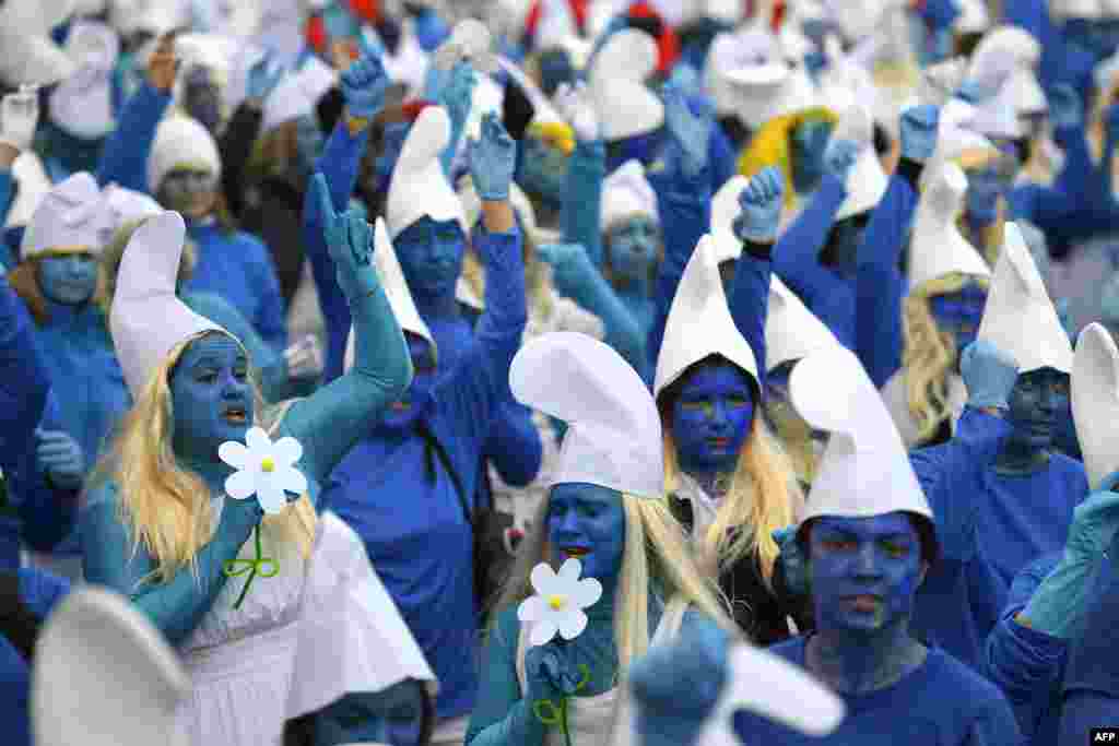 People dressed as Smurfs, a Belgian comic franchise centered on a fictional colony of small, blue, human-like creatures who live in mushroom-shaped houses in the forest, attend a world record gathering of Smurfs in Landerneau, western France, March 7, 2020.