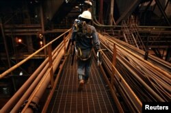 FILE - Workers walk along a pathway at the nickel smelter of PT Vale Tbk, near Sorowako, Indonesia, January 8, 2014. REUTERS/Yusuf Ahmad/File Photo