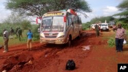 Kenyan security forces gather around the scene on an attack on a bus about 50 kilometers outside the town of Mandera on Nov. 22, 2014. There was another bus attack on Monday. (AP)