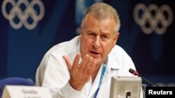 FILE - Disciplinary spokesman for the International Olympic Committee Francois Carrard - selected Aug. 11, 2015 to chair a group of leading reforms of FIFA's governing body - pauses during a news conference in Athens, Greece.