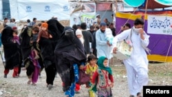 FILE - Internally Displaced Persons from South Waziristan leave for their hometown from Kawr camp in Pakistan's northwestern town of Tank, March 16, 2015. 