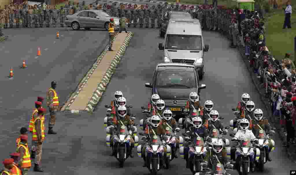 Defense force personnel and hospital staff salute a procession for former South African president Nelson Mandela as it leaves the military hospital in Pretoria, Dec. 11, 2013.