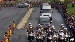 Defense force personnel and hospital staff salute a procession for former South African president Nelson Mandela as it leaves the military hospital in Pretoria, Dec. 11, 2013.