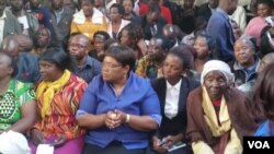 Zimbabwe People First leader Joice Mujuru and Victor Matemadanda (sitting behind Mujuru) attended Douglas Mahiya's court case in Harare on Monday.